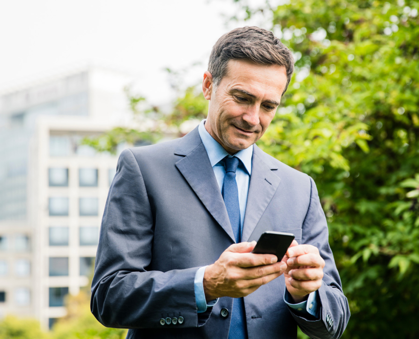 Political Figure Walking Down Street Looking At Texts